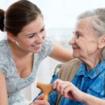 woman and her caregiver elderly woman smiling with her caregiver