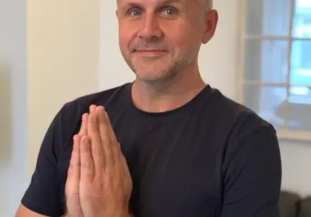 Photo of Dr David R Hamilton with his hands in prayer at the height of his chest.