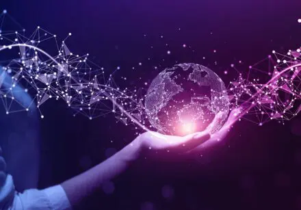 Woman holding a digital image of Earth in her right hand, with geometric shapes connected to it.