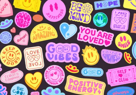 Cool, groovy colourful stickers on a black background. You are loved, good vibes, positive energy, you are amazing, kindness, and others of similar sentiment.