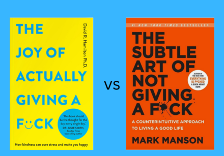 Image of two books against a light blue background. The image is one vs the other. One book is "The Joy of Actually Giving a Fck" by David R Hamilton PhD - yellow cover with light blue text - the other is "The Subtle Art of Not Giving a Fck" by Mark Manson - red cover and black text.