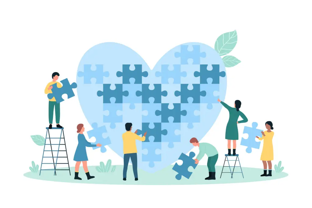 cartoon of 6 people (3 males, 3 females) building a giant pale blue heart out of giant jigsaw pieces.
