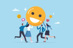 Cartoon image of 2 males and two females having fun holding up a large yellow smiley face, as if it was a giant balloon. The background is a blue sky. The men are wearing dark blue trousers and light blue tops, one woman is wearing a light blue skirt and white blouse, while the other is wearing a dark blue skirt, white blouse and light blue open jacket.