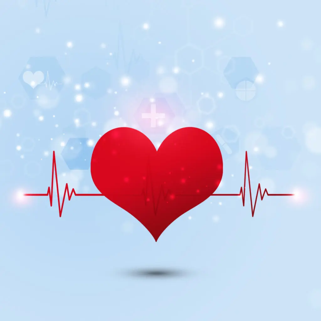 red heart against a light blue background. The heart has ECG lines on either side of it and the background has blurred out heart shapes, hexagons, and lights, depicting something magical and kind.