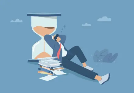 Illustration of slow down. Man in suit lying back against a giant hourglass taking a nap, with his papers and folders in a pile beside him. Set against a blue sky.