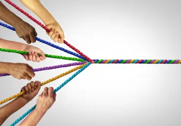 Image depicting psychological richness. Each experience colours who we becomes. Image shows different people holding a different colour of rope, and they all wind into a single multi-coloured rope