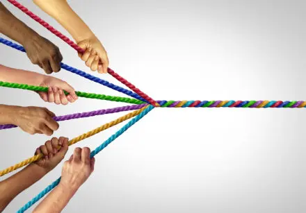 Image depicting psychological richness. Each experience colours who we becomes. Image shows different people holding a different colour of rope, and they all wind into a single multi-coloured rope