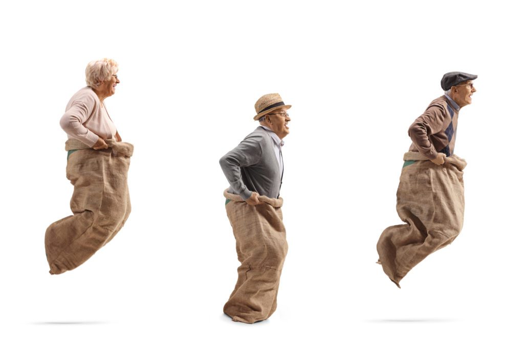 Older people in a sack race